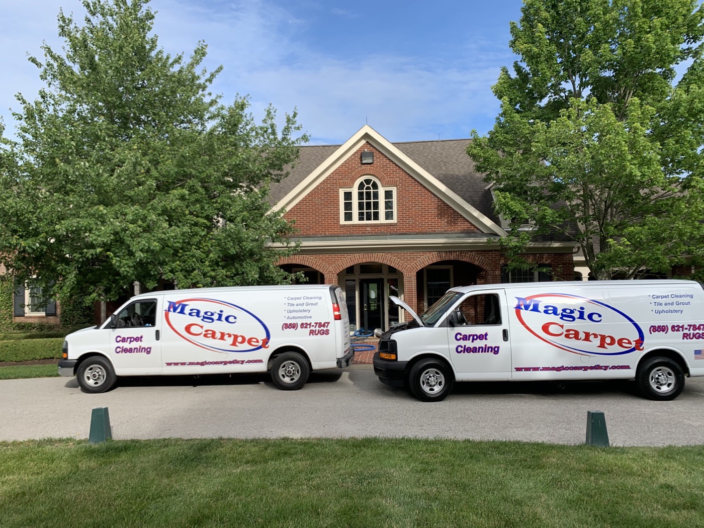 Both Magic Carpet vans parked in front of a Lexington home